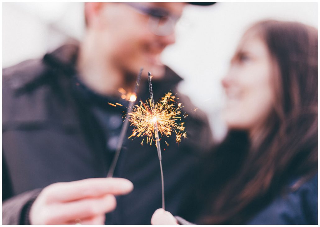 Couple holds sparkler